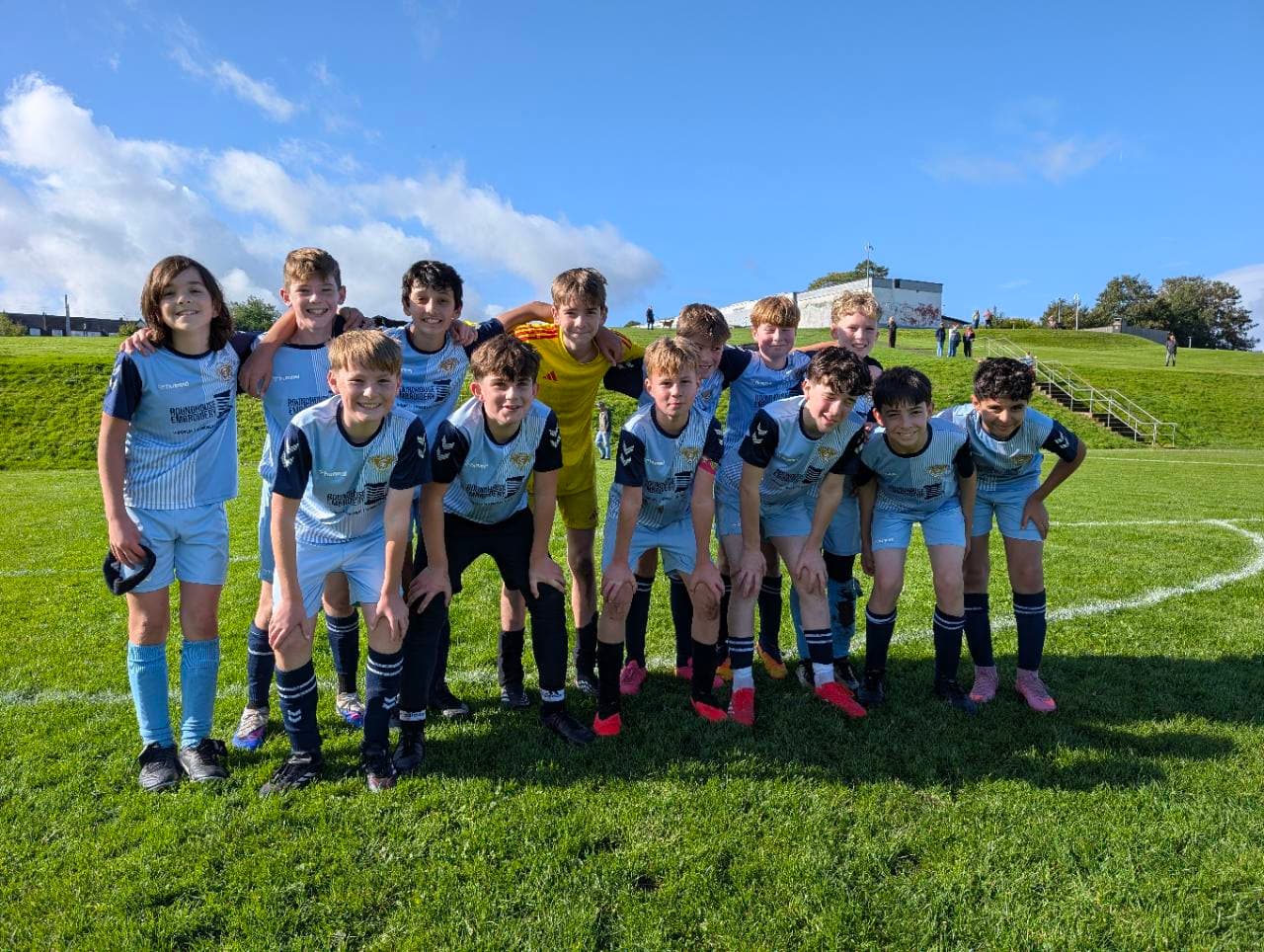 Wanderers players together on the pitch for their match against Carolside